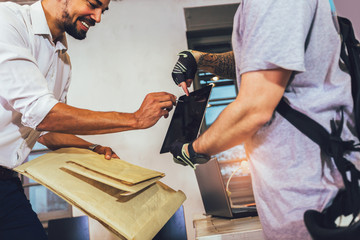 Man signing of delivery package.