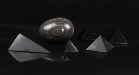 collection of abstract geometric stones on a black background
