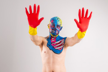 Quaint man with a painted head and shoullder in gloves isolated on white background