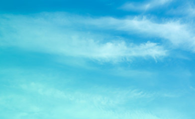 ิblue sky against white floating clouds background