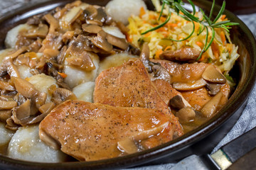 Stewed pork chop in a bright mushroom sauce.