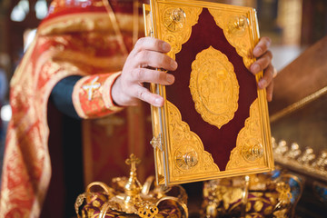 Fototapeta na wymiar priest holding golden bible