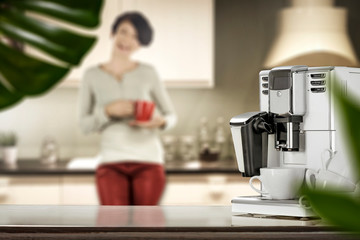 Desk of free space for your decoration and coffee machine.Slim young woman in kitchen 