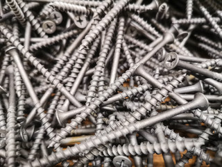 Texture of long metal strong self-cuts across wood in a wooden box. Background from chaotic self-cuts on the shelf