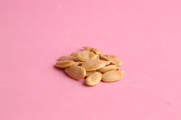 pumpkin seeds on color background