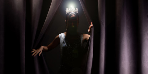 Miss Pageant Beauty Contest wears sequin Evening Gown long dress with sparkle Diamond Crown, Asian Woman opens purple Curtain after win Final round as new way life, opportunity, change everything © Jade