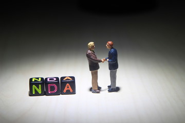 Simple Illustration Photo, NDA, No Disclosure Agreement, Two Man Handshaking make a Illegal...