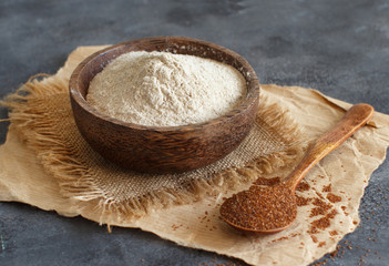 Teff flour in a bowl and teff grain with a spoon