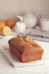 Lemon bread. Cake with citrus and poppy on cutting board, traditional american cuisine. Whole loaf