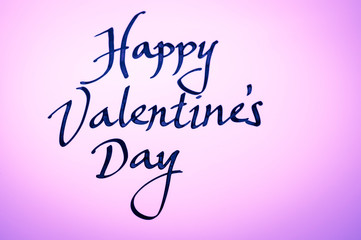 Handwritten Happy Valentine's Day message in simple calligraphic script on glowing pink background