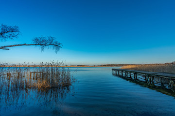 Old wooden landing stage at a tranquil lake