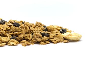 Fototapeta na wymiar Organic homemade crunchy Granola cereal pile on white background. The ingredients mixed with maltflakes, oats, dried raisins and cashew nut.