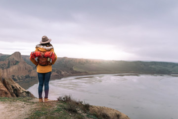 young girl traveling the world with her backpack hiking