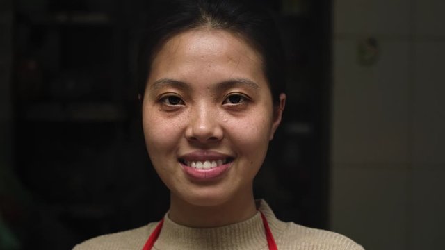 Handheld view of Vietnamese woman looking at camera. Shot with RED helium camera in 8K