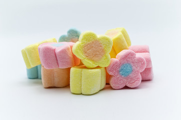 Pastel sweet flowers shape of marshmallows on white background.