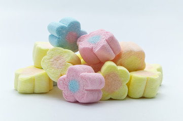 Pastel sweet flowers shape of marshmallows on white background.