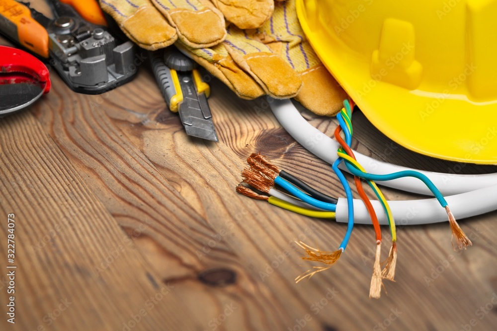 Wall mural yellow hard hat and leather work gloves on wooden desk