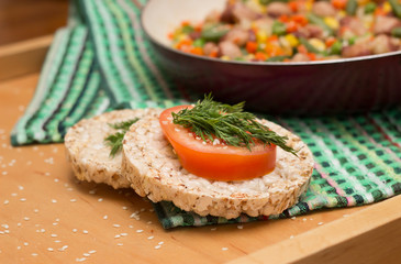 Sandwiches crispy bread with tomato and dill on a wooden tray