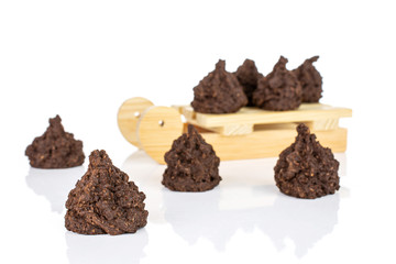 Group of eight whole homemade brown coconut cocoa biscuit with wooden sledge isolated on white background
