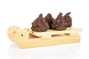 Group of four whole homemade brown coconut cocoa biscuit with wooden sledge isolated on white background