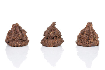 Group of three whole homemade brown coconut cocoa biscuit in row isolated on white background