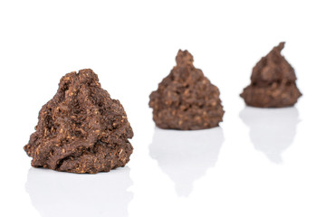Group of three whole homemade brown coconut cocoa biscuit placed diagonally isolated on white background