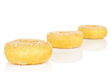 Group of three whole sweet golden mini cinnamon donut isolated on white background