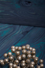 Decorative bouquet of golden balls. Against the background of brushed boards painted in black and green.