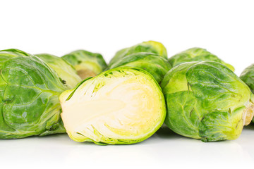 Lot of whole one half of fresh green brussels sprout isolated on white background