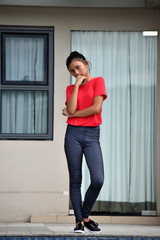 Thinking Young Filipina Girl Standing By Condo