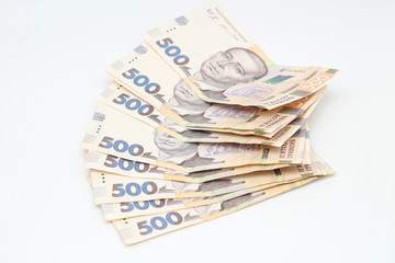 Fan of new banknotes in denominations of 500 Ukrainian hryvnias isolated on a white background with shadow. European money exchange. Ukraine currency