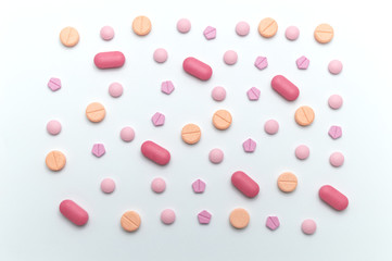 Different colorful drugs or medicine pills tablet supplements for the treatment and health care on a white background.