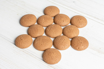 Lot of whole sweet brown chocolate sponge biscuit on white wood