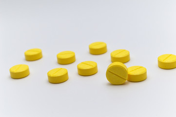 Prescription drugs,medicine of tablets or pills with yellow color. On white background and Selective focus.