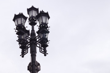 Fototapeta na wymiar forged street lamps against the sky