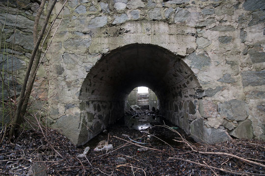 Culvert, drain under road for small river. Concrete culvert is a structure that allows water to flow under a road  from one side to the other side.