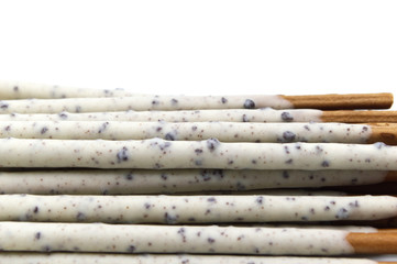 Chocolate biscuit stick coated with milk flavour confectionery and crushed cookies and cream taste isolated on white background.