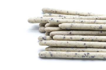 Chocolate biscuit stick coated with milk flavour confectionery and crushed cookies and cream taste isolated on white background.