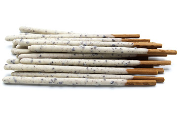 Chocolate biscuit stick coated with milk flavour confectionery and crushed cookies and cream taste isolated on white background.