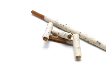 Chocolate biscuit stick coated with milk flavour confectionery and crushed cookies and cream taste isolated on white background.