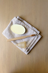 Linen cloth, soap, bamboo toothbrush and menstrual cup. Zero waste bathroom products. Top view.