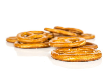 Lot of whole baked salty brown pretzel isolated on white background