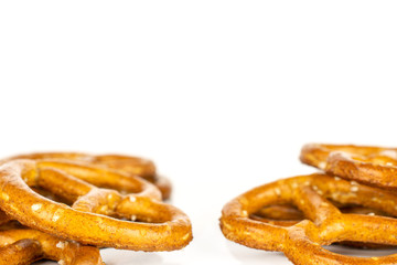 Lot of whole salty brown pretzel isolated on white background