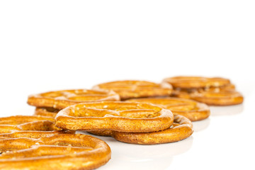 Lot of whole salty brown pretzel isolated on white background