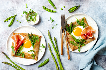 Buckwheat crepes, galette bretonne with asparagus, egg, green pea, jambon or prosciutto. Galette sarrasin, french brittany cuisine