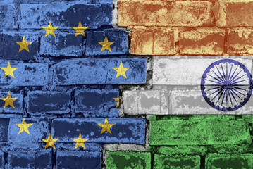 The flag of the European Union and India on a brick wall