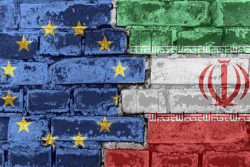 The flag of the European Union and Iran on a brick wall