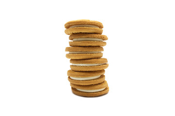 Stack of sandwich cookies milk flavoured cream isolated on white background.