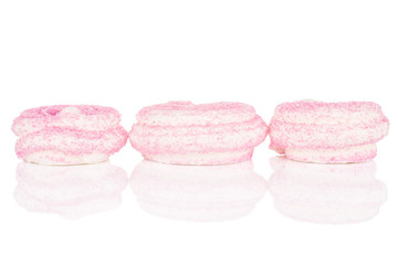 Obraz na płótnie Canvas Group of three whole pink sweet meringue in row isolated on white background
