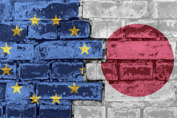 The flag of the European Union and Japan on a brick wall